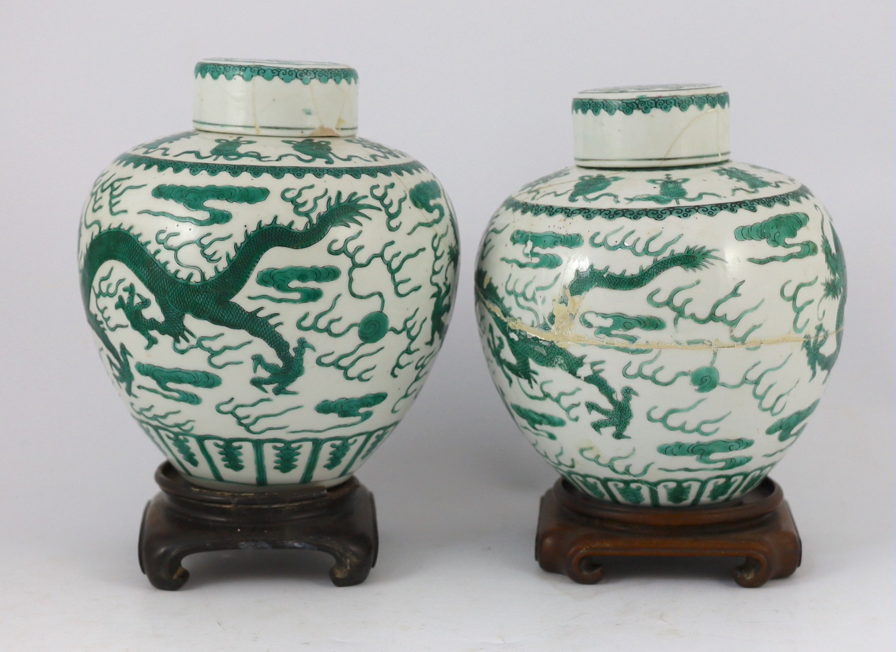 Two similar Chinese green enamelled ‘dragon’ jars and covers, Daoguang mark and period (1821-50), 21.5cm high, damaged and repaired